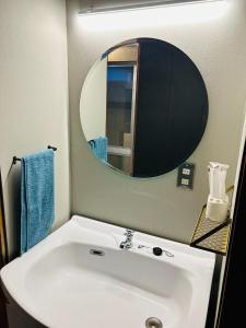 a bathroom with a white sink and a mirror at Takemi no Yado - Vacation STAY 97130v in Yufuin