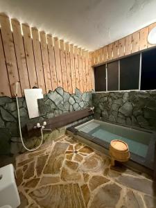 a bathroom with a bath tub with a toilet at Takemi no Yado - Vacation STAY 97130v in Yufuin