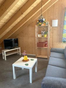 a living room with a couch and a table at Holzliebe mit Donaublick in Kaisheim