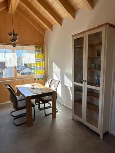 a dining room with a table and chairs and a window at Holzliebe mit Donaublick in Kaisheim