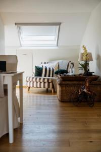 a living room with couches and a bike in a room at B&B Hof van Vervoering in Voeren