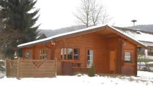 a log cabin with snow on the ground at Ferienhaus Pöttgen in Arnsberg