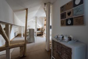 a living room with a staircase and a room with a stair at B&B Hof van Vervoering in Voeren