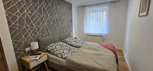 Ένα ή περισσότερα κρεβάτια σε δωμάτιο στο Apartament 9 Delux - Bliżej Zdroju