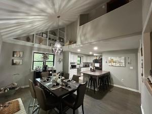 a dining room and kitchen with a table and chairs at Woodsy home near Wineries, Hiking, & River in Dahlonega