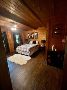 a bedroom with a bed in a wooden room at Woodsy home near Wineries, Hiking, & River in Dahlonega