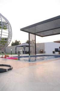 a swimming pool with a ferris wheel in the background at B&B Villa in Ras al Khaimah