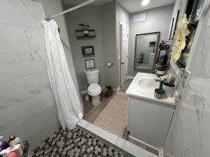 a bathroom with a shower and a toilet and a sink at Woodsy home near Wineries, Hiking, & River in Dahlonega +39 photos