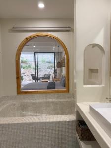 a bathroom with a mirror and a sink and a tub at Casa D' Elysea in Phu Quoc +83 photos