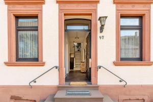 a hallway of a house with two windows at Ferienwohnung Fuchsbau in Neumagen-Dhron