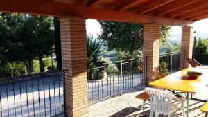 a patio with a table and chairs and a fence at Agriturismo Il Melo in Valfabbrica +30 photos