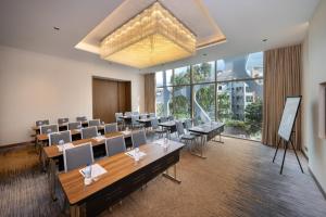 a conference room with desks and chairs and a large window at Hyatt Place Dhaka Uttara in Dhaka +30 photos