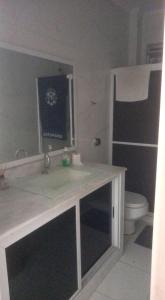 a bathroom with a sink and a toilet at Vila Hostel Santos in Santos