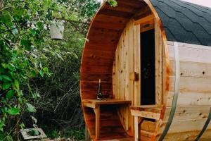 a small wooden sauna with a table in it at 1 Bed Tiny House Sleeps 2 -Hot Tub -Coal Fireplace in Liglet