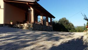 a house with a stone porch with a roof at Agriturismo Il Melo in Valfabbrica
