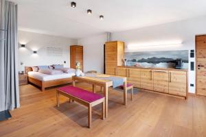 a bedroom with a bed and a table in a room at Ansitz Röfen in Burgusio