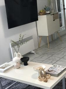 a white table with a tv on top of it at Urban Oasis in Toronto +19 photos