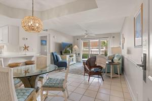 a kitchen and living room with a table and chairs at Beach Club, Unit 134 in East End