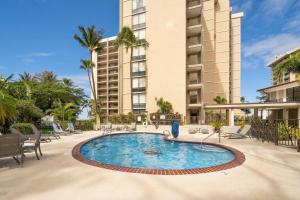 a swimming pool in front of a building at Valley Isle 401 · VI 401 Remodeled OceanFront Condo w Ocean View in Kahana