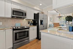 a kitchen with a stove and a refrigerator at Ocean Front Escape - 1106 Beachview Dr in Demere Park