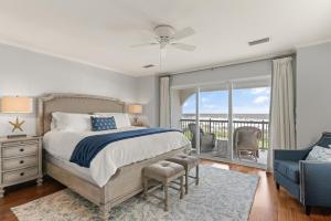 a bedroom with a bed and a balcony at Ocean Front Escape - 1106 Beachview Dr in Demere Park