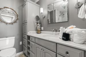 a bathroom with a sink and a toilet and a mirror at Ocean Front Escape - 1106 Beachview Dr in Demere Park +25 photos