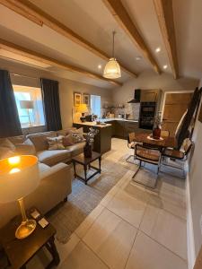 a living room with a couch and a table at Holly Cottage - Village location, Lake District in Penrith