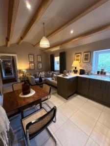 a large living room with a table and a couch at Holly Cottage - Village location, Lake District in Penrith