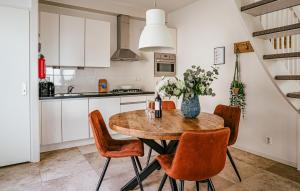 a kitchen and dining room with a wooden table and chairs at Flat Fish in Egmond aan Zee