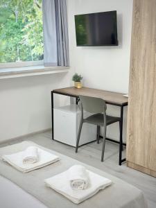 a room with a desk and a table and a chair at Студия за нощувки - Стара Загора in Stara Zagora