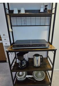 a shelf with a laptop on top of it at Alphonse in Felletin