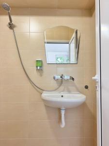 a bathroom with a sink and a mirror at Студия за нощувки - Стара Загора in Stara Zagora
