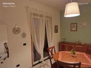 a dining room with a table and a window at I capricci dell' Etna suite in Mascalucia