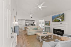 a living room with a couch and a fireplace at Point Five - 1133 Mallery St in Saint Simons Island