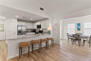 a kitchen and dining room with a table and chairs at Point Five - 1133 Mallery St in Saint Simons Island