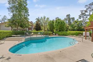 Harbour Oaks, Unit 618 في Demere Park: مسبح كبير في ساحه فيها اشجار
