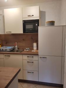 Ferienwohnung Hilde في باد بيترستال غريسب: مطبخ مع ثلاجة بيضاء وميكروويف