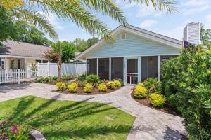 a house with atropical garden in front of it at Point Five - 1133 Mallery St in Saint Simons Island