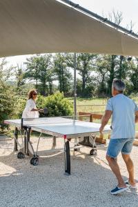 a man and a woman playing a table tennis at La Clé des Chaumes - Chambre d'hôte, Bed and Breakfast avec piscine et bain nordique in Boisset-lès-Montrond