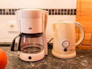 a blender sitting on a counter next to an orange at Ferienwohnung Knopf in Schömberg
