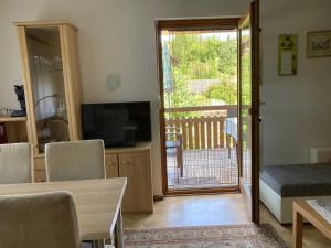 a living room with a sliding glass door to a balcony at Gästehaus Linde in Endingen