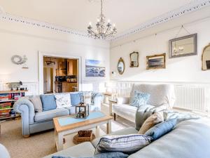 a living room with couches and a table at Apartment 1 - Uk32244 in Aberdyfi
