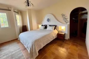 a bedroom with a large bed with white sheets and pillows at Beautiful House With Splendid Sea in La Herradura