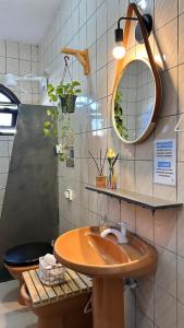 a bathroom with a wooden sink and a toilet at Odoyá Casa Hostel in Arraial d'Ajuda +54 photos