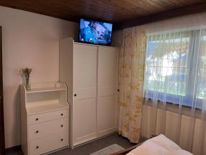 a bedroom with a tv on top of a wall at Haus Fischer in Pettneu am Arlberg +48 photos
