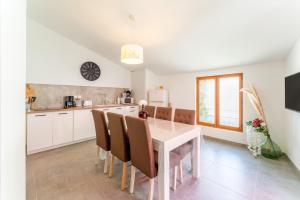 a kitchen and dining room with a table and chairs at La Bonbonnière Gîte De Charme in Malaucène