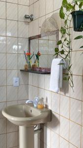 a bathroom with a sink and a mirror at Odoyá Casa Hostel in Arraial d'Ajuda