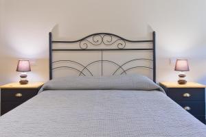 Sardón de los FrailesにあるTurísticos Sardón de los Frailesの大きなベッドと2つのナイトスタンドを備えた寝室