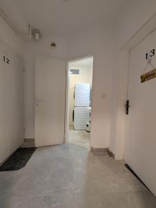 a room with a hallway with white walls and a door at Fully Equipped Studio in Sesvete in Sesvete +6 photos