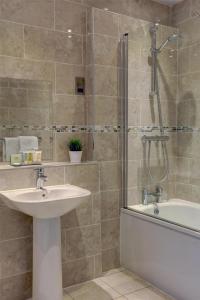 a bathroom with a sink and a tub and a shower at The Craiglands Hotel Sure Hotel Collection by Best Western in Ilkley
